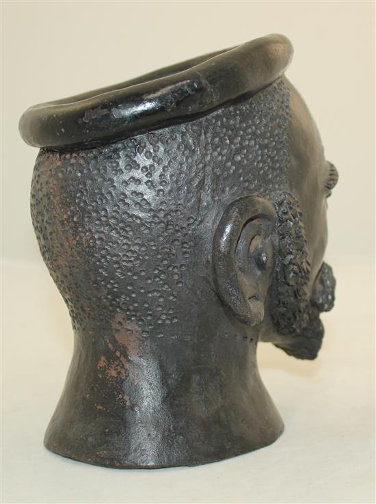 An African painted terracotta jar modelled as the head of a bearded man, 7.5in.